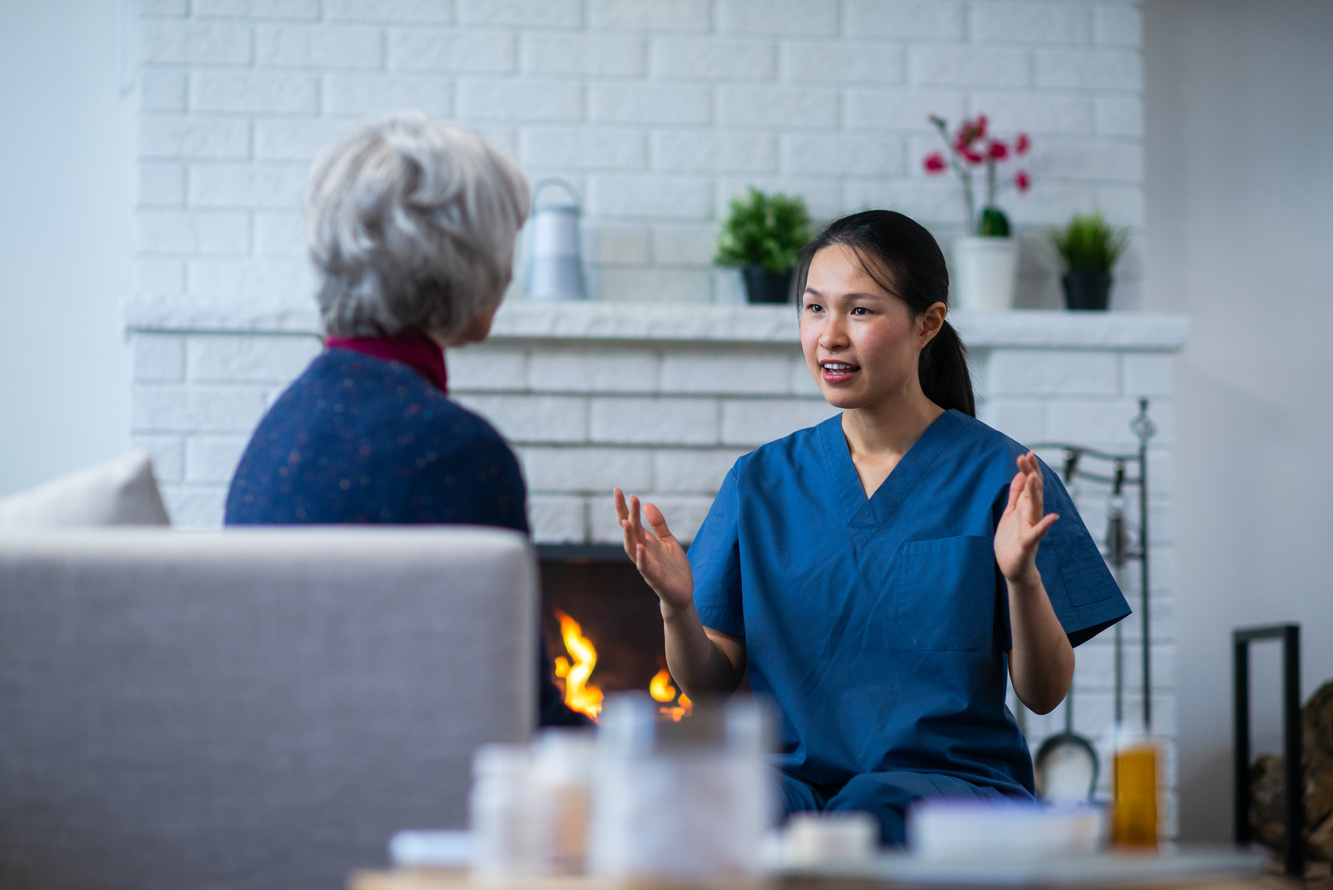 Home Care Nurse Visits Elderly Woman stock photo
